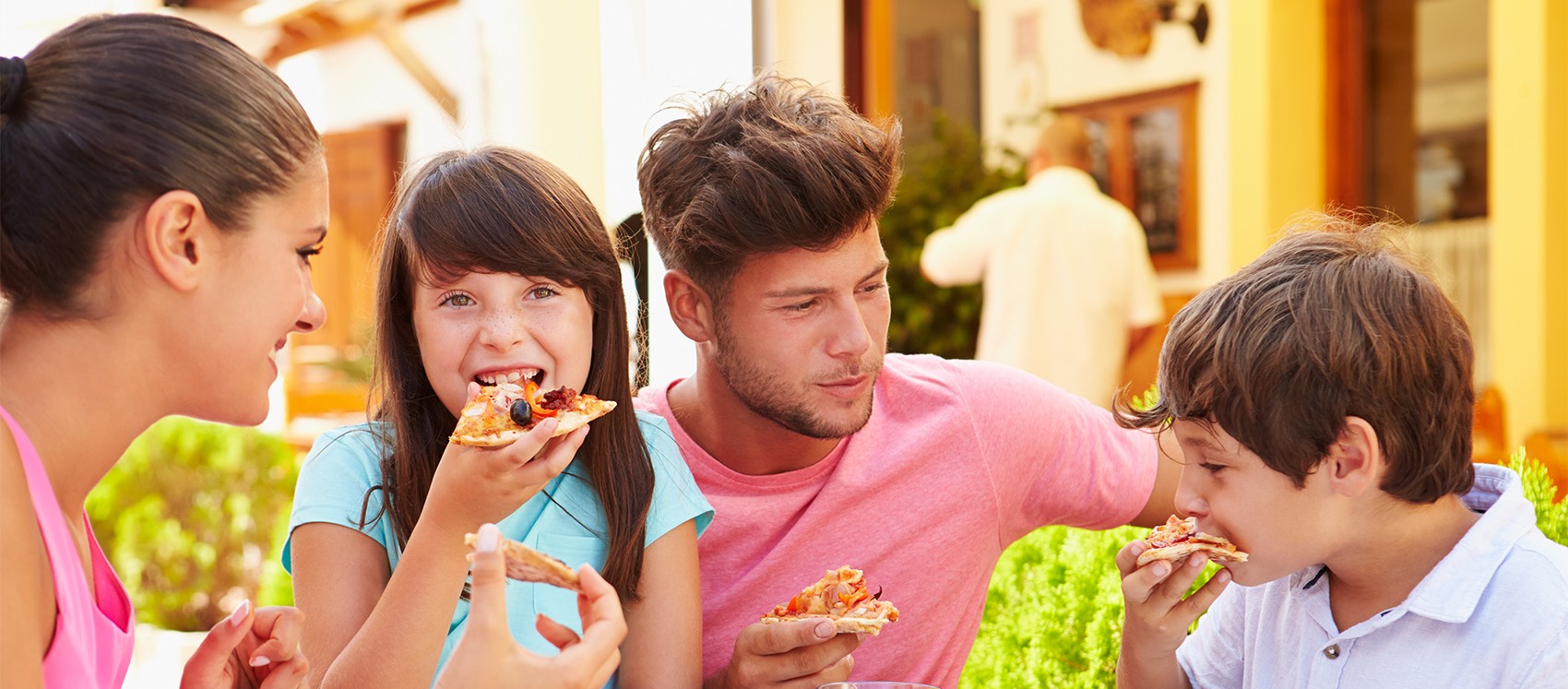 family eating pizza at a restaurant